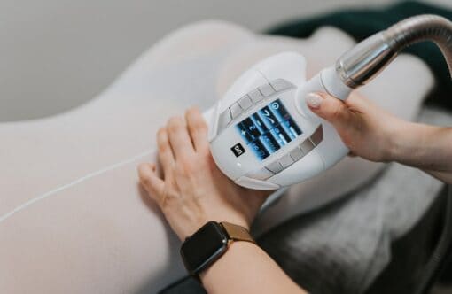 Advanced cellulite reduction treatment with SLIMM radiofrequency device at a modern clinic.