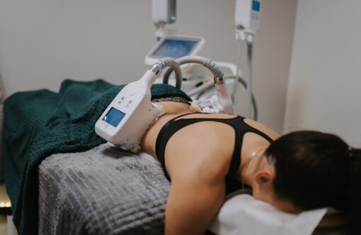 Radio frequency body contouring treatment on woman lying face down in clinic room, Slimming, non-invasive fat reduction, body sculpting technology, optimal aesthetic results, skincare, body transformation, SLIMM.