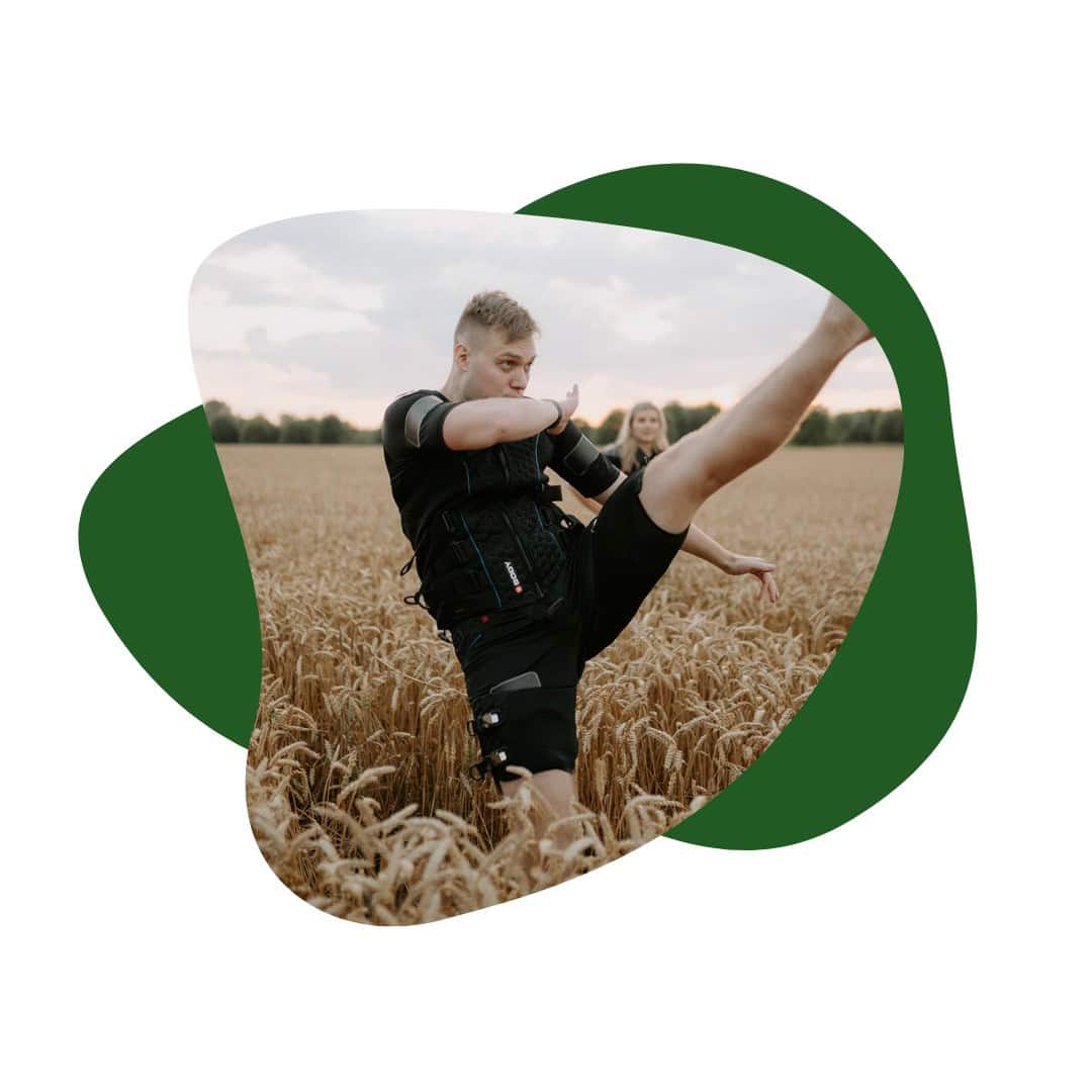 Meditation outside in nature performing yoga stretching in a wheat field with a young man and woman, health and wellness, outdoor exercise, relaxation, mindfulness, healthy lifestyle, fitness outdoor scenery, sunset lighting.